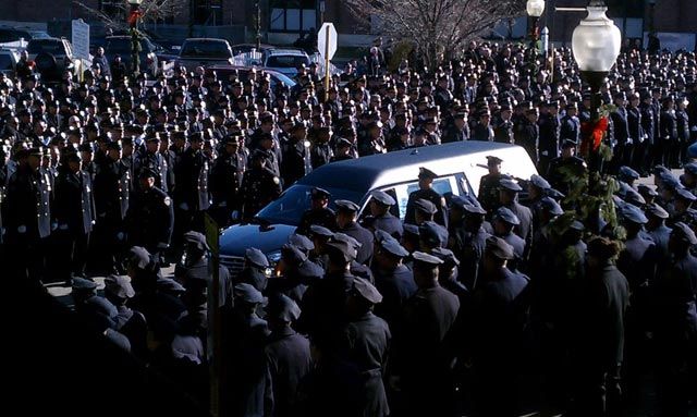 Police officers line the streets to pay respects to slain NYPD Officer Peter Figoski